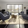Resident lounge with modern seating and large windows