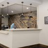 Clubhouse kitchen with pendant lights and wood accent wall