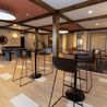 Clubhouse with bar-height seating and exposed beams