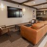 Clubhouse lounge with leather sofa and wall-mounted TV
