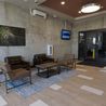 Lobby lounge with seating and concrete walls