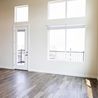 Living room with tall windows and balcony door