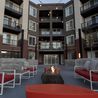 Courtyard with fire table and red lounge seating