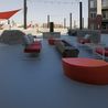 Outdoor lounge with red seating and shade sails