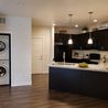 Staged kitchen with stacked washer and dryer