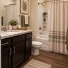 Staged bathroom with dark vanity