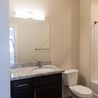 Bathroom with granite vanity and dark cabinets